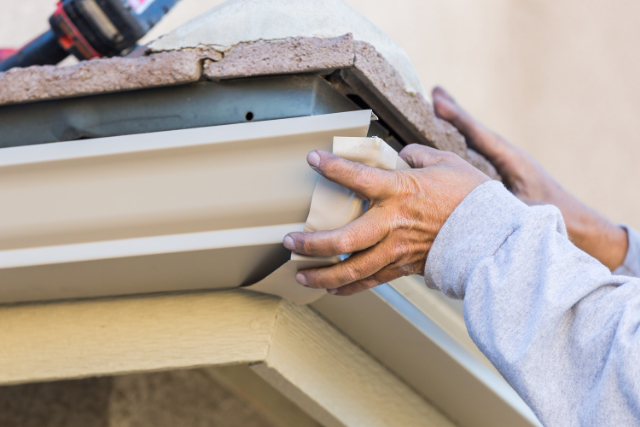 Bend Gutter Repair by worker